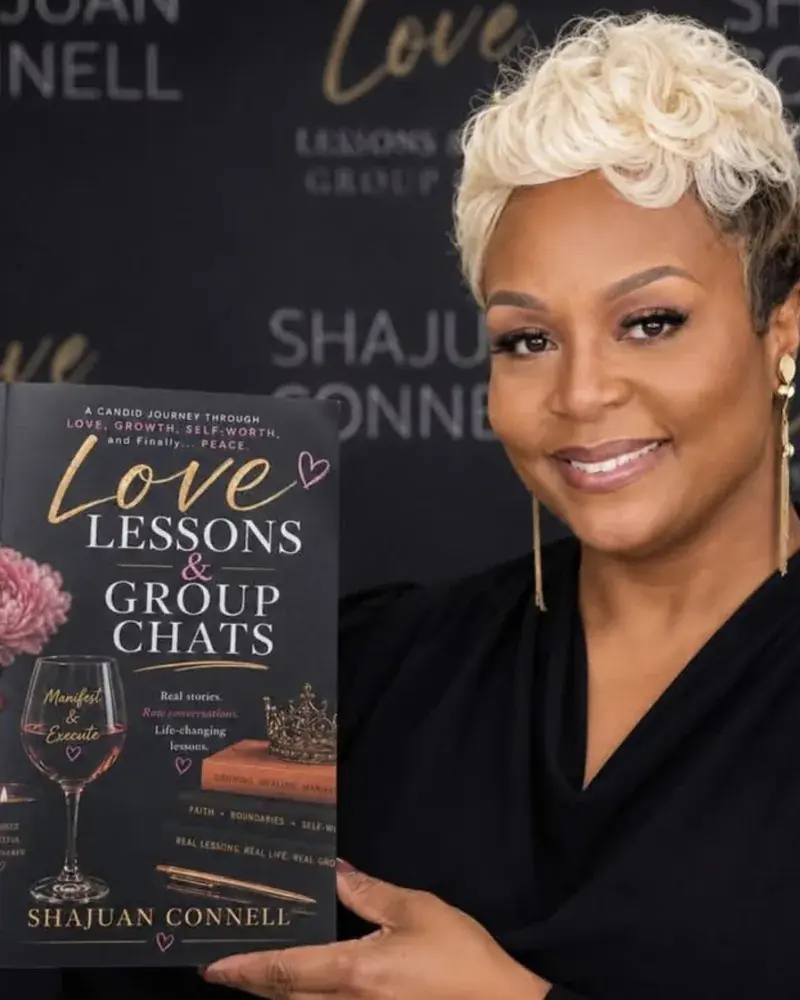 Shajuan Connell holding her book Love Lessons & Group Chats